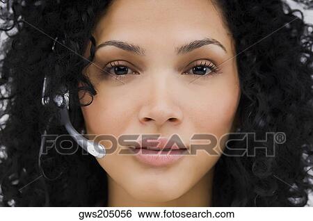 Portrait of a female customer service representative wearing a headset View Large Photo Image Stock Photograph - Portrait of a female customer service representative wearing a headset. Fotosearch