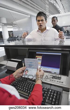 Businessman looking angry at a ticket counter in an airport View Large Photo Image Picture - Businessman looking angry at a ticket counter in an airport. Fotosearch