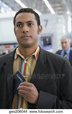 Close-up of a businessman putting a passport in his coat's pocket View Large Photo Image Picture - Close-up of a businessman putting a passport in his coat's pocket. Fotosearch