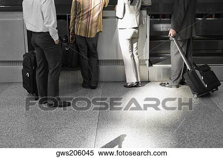 Low section view of four people standing at an airport View Large Photo Image Stock Photography - Low section view of four people standing at an airport. Fotosearch