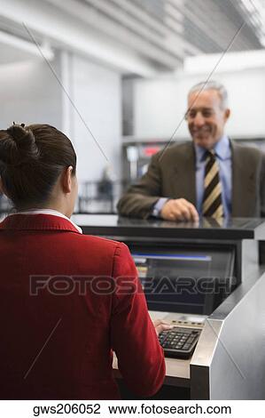 Rear view of an airline check-in attendant View Large Photo Image Stock Image - Rear view of an airline check-in attendant. Fotosearch