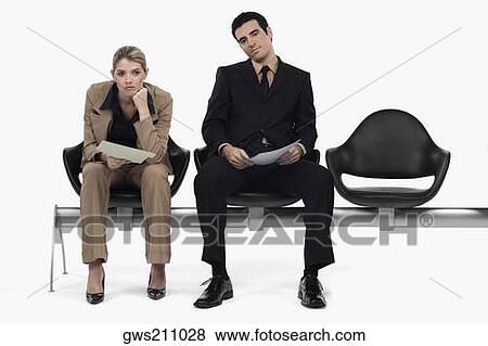 Stock Photo - Businessman and a businesswoman sitting on a bench. Fotosearch