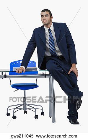 Stock Photography - Businessman sitting at a desk and thinking. Fotosearch