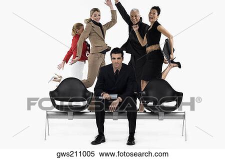 Businessman sitting on a bench with four business executives jumping in excitement behind him View Large Photo Image Stock Photography - Businessman sitting on a bench with four business executives jumping in excitement behind him. Fotosearch