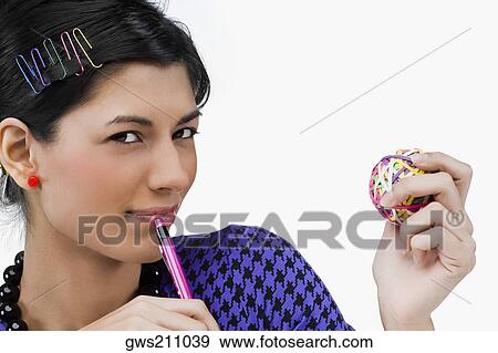 Portrait of a young woman holding rubber bands and a pen View Large Photo Image Stock Photo - Portrait of a young woman holding rubber bands and a pen. Fotosearch