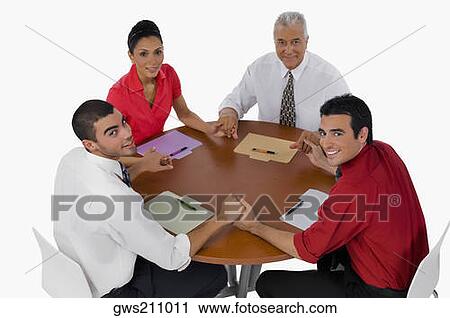 Portrait of three businessmen and a businesswoman sitting with holding their hands in a meeting View Large Photo Image Stock Image - Portrait of three businessmen and a businesswoman sitting with holding their hands in a meeting. Fotosearch