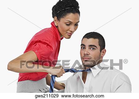 Side profile of a businesswoman pulling a businessman with his tie View Large Photo Image Stock Photo - Side profile of a businesswoman pulling a businessman with his tie. Fotosearch