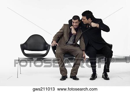 Two businessmen having a playful fight View Large Photo Image Stock Image - Two businessmen having a playful fight. Fotosearch