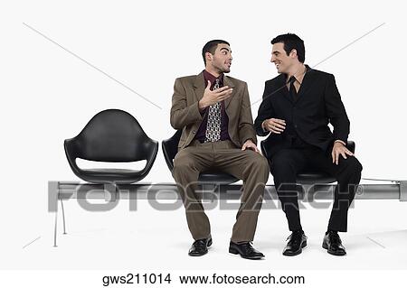 Two businessmen talking to each other View Large Photo Image Picture - Two businessmen talking to each other. Fotosearch