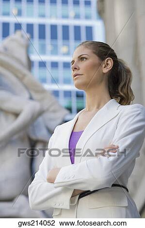 Stock Image - Businesswoman standing with her arms crossed. Fotosearch
