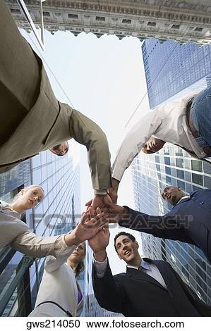Low angle view of business executives stacking hands View Large Photo Image Stock Image - Low angle view of business executives stacking hands. Fotosearch