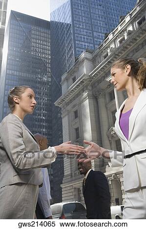 Low angle view of two businesswomen shaking hands View Large Photo Image Stock Photography - Low angle view of two businesswomen shaking hands. Fotosearch