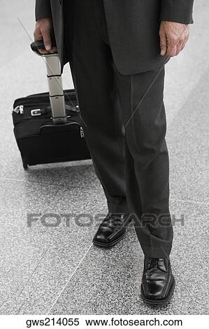 Low section view of a businessman with a luggage View Large Photo Image Stock Photography - Low section view of a businessman with a luggage. Fotosearch