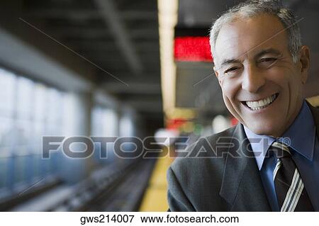 Portrait of a businessman smiling at a subway station View Large Photo Image Stock Photo - Portrait of a businessman smiling at a subway station. Fotosearch