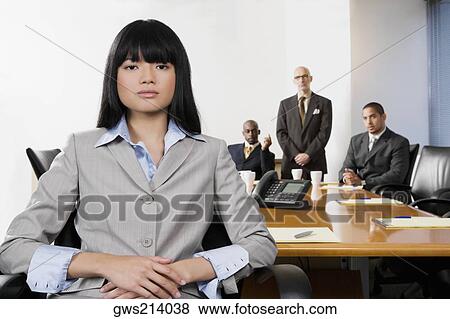 Portrait of a businesswoman with her colleagues in the background View Large Photo Image Stock Photo - Portrait of a businesswoman with her colleagues in the background. Fotosearch