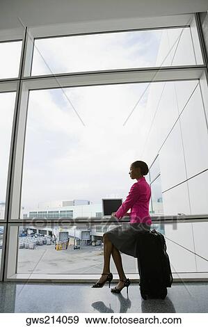 Side profile of a businesswoman using a laptop in a waiting room View Large Photo Image Stock Photo - Side profile of a businesswoman using a laptop in a waiting room. Fotosearch