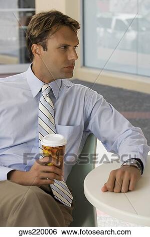 Businessman holding a coffee cup and thinking View Large Photo Image Stock Photograph - Businessman holding a coffee cup and thinking. Fotosearch
