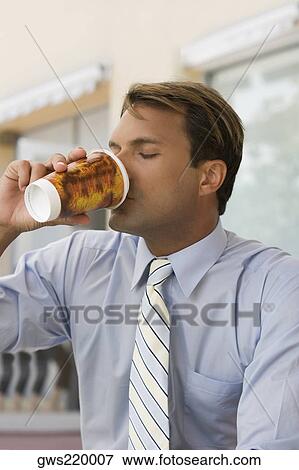 Close-up of a businessman drinking coffee View Large Photo Image Stock Photo - Close-up of a businessman drinking coffee. Fotosearch
