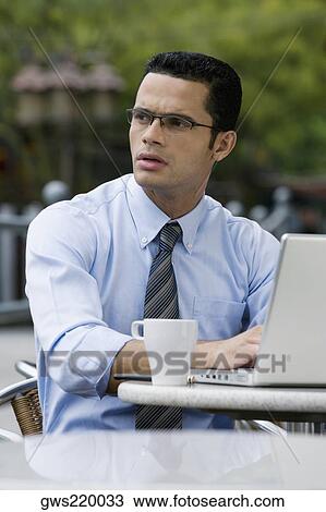 Close-up of a businessman thinking while using a laptop View Large Photo Image Stock Image - Close-up of a businessman thinking while using a laptop. Fotosearch