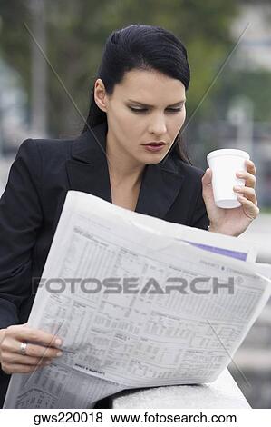 Close-up of a businesswoman reading a newspaper View Large Photo Image Stock Photo - Close-up of a businesswoman reading a newspaper. Fotosearch