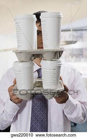 Portrait of a businessman holding disposable cups View Large Photo Image Stock Image - Portrait of a businessman holding disposable cups. Fotosearch