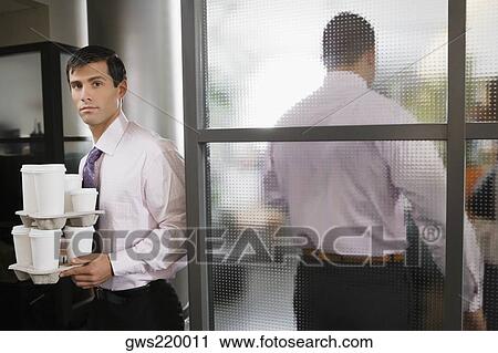Portrait of a businessman holding disposable cups View Large Photo Image Stock Image - Portrait of a businessman holding disposable cups. Fotosearch
