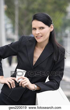 Portrait of a businesswoman holding a disposable cup and smiling View Large Photo Image Stock Photo - Portrait of a businesswoman holding a disposable cup and smiling. Fotosearch