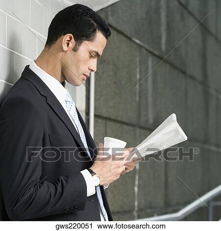 Side profile of a businessman reading a newspaper View Large Photo Image Stock Image - Side profile of a businessman reading a newspaper. Fotosearch