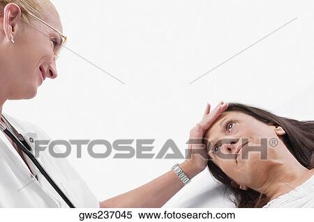 Close-up of a female doctor examining a mature woman View Large Photo Image Stock Photography - Close-up of a female doctor examining a mature woman. Fotosearch