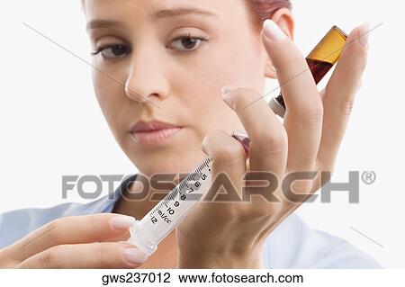 Close-up of a female doctor filling a syringe View Large Photo Image Stock Image - Close-up of a female doctor filling a syringe. Fotosearch