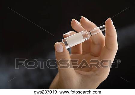 Close-up of a female doctor holding a vial View Large Photo Image Stock Photo - Close-up of a female doctor holding a vial. Fotosearch