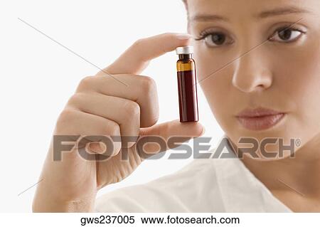 Close-up of a female doctor holding a vial View Large Photo Image Stock Photography - Close-up of a female doctor holding a vial. Fotosearch