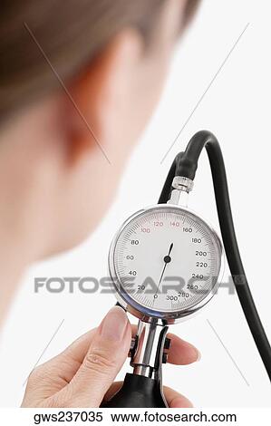 Close-up of a female doctor holding a blood pressure gauge View Large Photo Image Stock Photography - Close-up of a female doctor holding a blood pressure gauge. Fotosearch