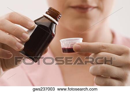 Close-up of a female doctor pouring syrup View Large Photo Image Stock Image - Close-up of a female doctor pouring syrup. Fotosearch