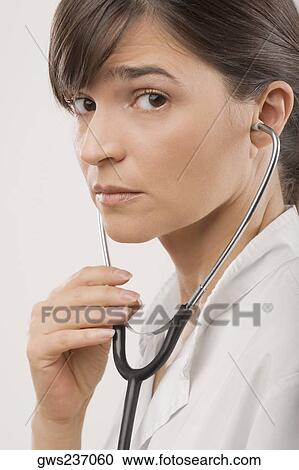 Close-up of a female doctor wearing a stethoscope View Large Photo Image Stock Image - Close-up of a female doctor wearing a stethoscope. Fotosearch