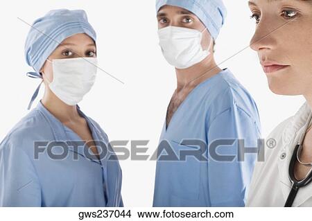 Close-up of a female doctor with two surgeons View Large Photo Image Picture - Close-up of a female doctor with two surgeons. Fotosearch