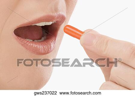 Close-up of a patient taking a capsule View Large Photo Image Stock Image - Close-up of a patient taking a capsule. Fotosearch