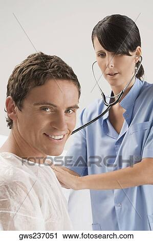 Female surgeon examining a mid adult man View Large Photo Image Stock Image - Female surgeon examining a mid adult man. Fotosearch