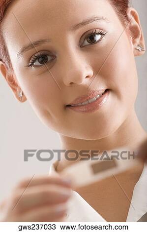 Stock Image - Portrait of a female doctor holding an adhesive bandage. Fotosearch