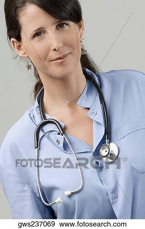Portrait of a female doctor smiling View Large Photo Image Stock Photo - Portrait of a female doctor smiling. Fotosearch