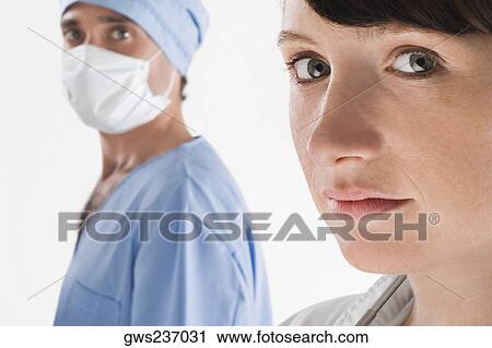 Portrait of a female doctor with a male surgeon View Large Photo Image Stock Image - Portrait of a female doctor with a male surgeon. Fotosearch