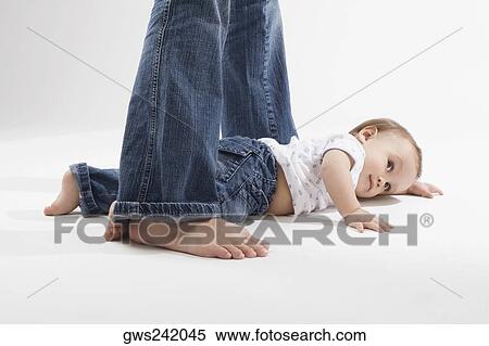Stock Photography - Close-up of a baby boy lying on the floor. Fotosearch