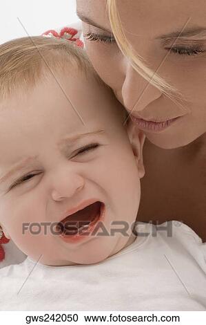 Close-up of a mid adult woman consoling her son View Large Photo Image Stock Image - Close-up of a mid adult woman consoling her son. Fotosearch