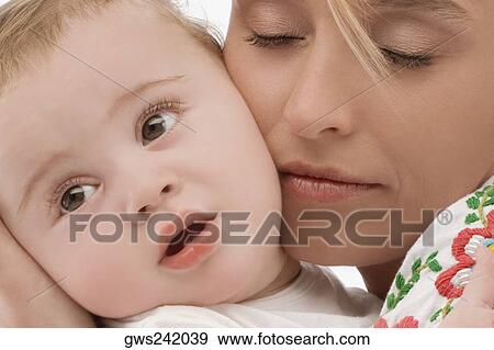 Close-up of a mid adult woman loving her son View Large Photo Image Stock Photo - Close-up of a mid adult woman loving her son. Fotosearch