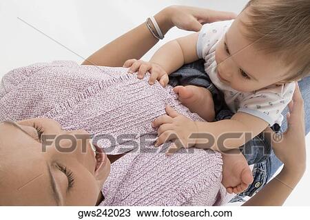 Close-up of a mid adult woman playing with her son View Large Photo Image Stock Image - Close-up of a mid adult woman playing with her son. Fotosearch