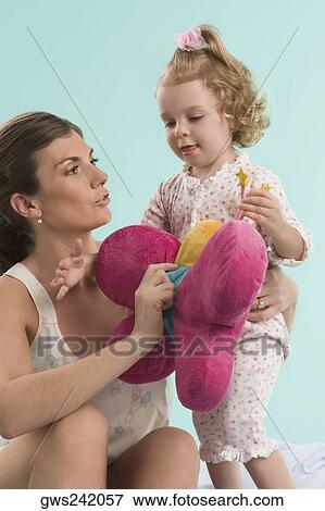 Close-up of a mid adult woman playing with her daughter View Large Photo Image Stock Photo - Close-up of a mid adult woman playing with her daughter. Fotosearch