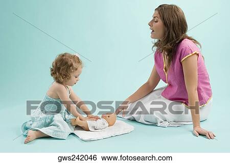 Close-up of a mid adult woman playing with her daughter View Large Photo Image Stock Photograph - Close-up of a mid adult woman playing with her daughter. Fotosearch