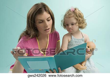 Stock Photograph - Close-up of a mid adult woman teaching her daughter. Fotosearch