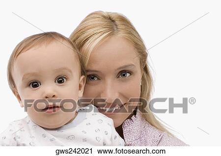 Portrait of a mid adult woman smiling with her son View Large Photo Image Stock Image - Portrait of a mid adult woman smiling with her son. Fotosearch