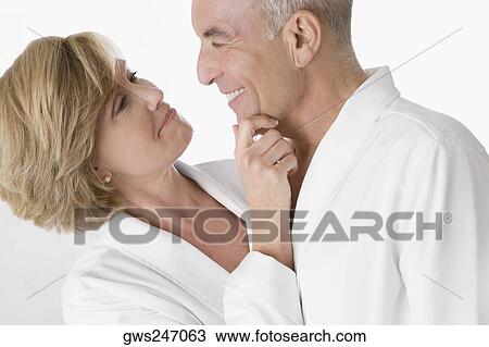 Close-up of a mature woman with a senior man embracing and looking at each other View Large Photo Image Stock Image - Close-up of a mature woman with a senior man embracing and looking at each other. Fotosearch